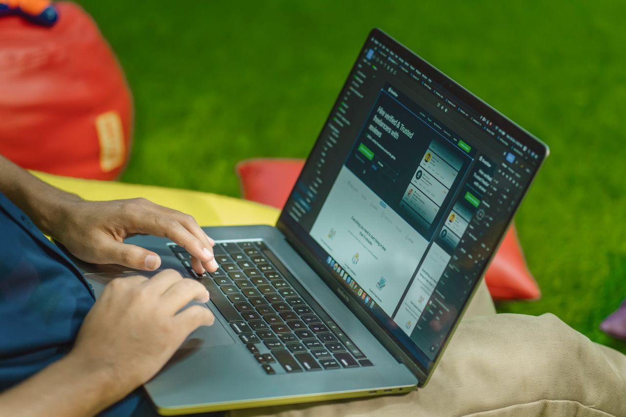 Crafting Captivating Headlines: Your awesome post title goes here A person using a laptop outdoors on a sunny day, showcasing digital nomad lifestyle.